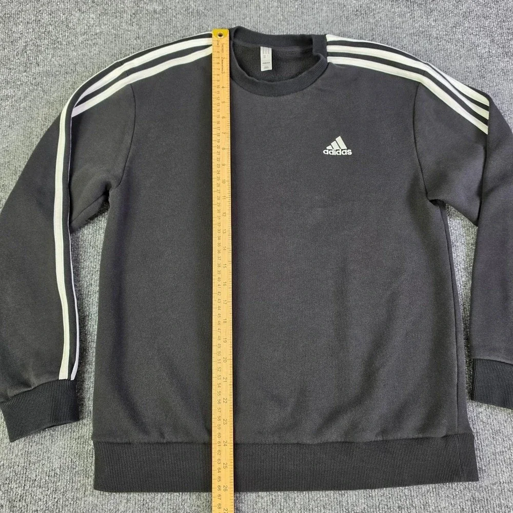 Adidas black crewneck sweatshirt with white stripes on sleeves, size M